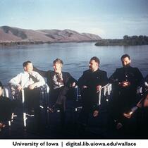 Henry Wallace, third from left, and dignitaries seated by lake, China 1944