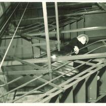 Man descending backstage stairs in Theatre Building, The University of Iowa, 1930s