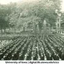 Commencement on the Pentacrest with the Hall of Liberal Arts in background, The University of Iowa, June 1928